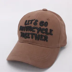 Detailed view of the 3D embroidered lettering on a brown cotton twill baseball cap
