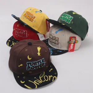 Detailed view of kids flat brim baseball caps in five colors with Turtle Power embroidery