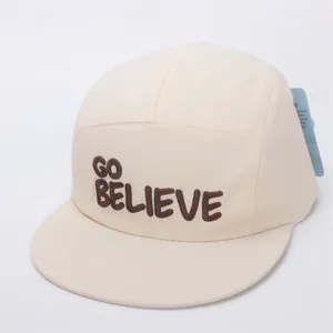 Close-up of beige camper hat featuring brown GO BELIEVE 3D embroidery and cotton texture