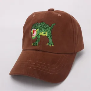 Detail of a brown corduroy baseball cap with a green dinosaur embroidery for children