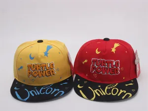 Detail shot of embroidered Turtle Power and Unicorn text on flat-brim snapback hats