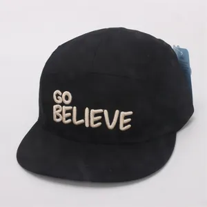 Detail of embroidered GO BELIEVE letters on black flat brim cotton baseball cap