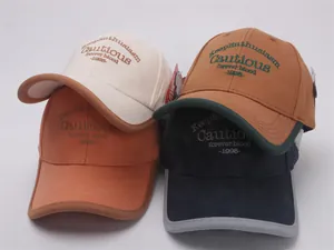 Detail view of children's baseball caps in four colors with high-quality embroidery