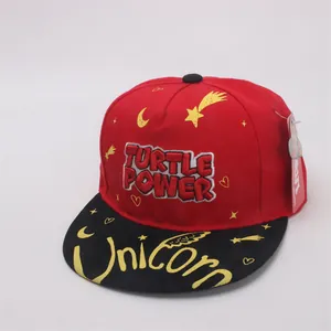 Detail of red and black kids hip hop cap with Turtle Power embroidery and graffiti brim