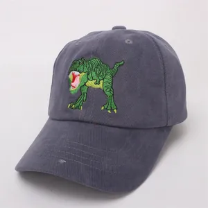 Detail of dark grey corduroy fabric and green dinosaur embroidery on kids baseball cap