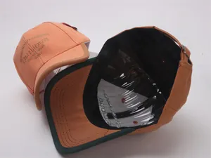 Detail of kids baseball cap with cautious embroidery, contrast piping, and metal buckle