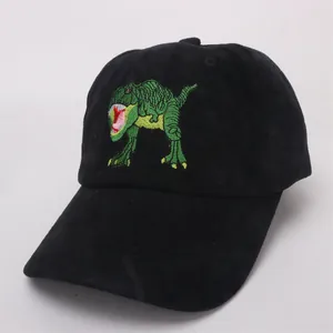 Detailed view of green T-Rex embroidery on a black cotton baseball cap for kids