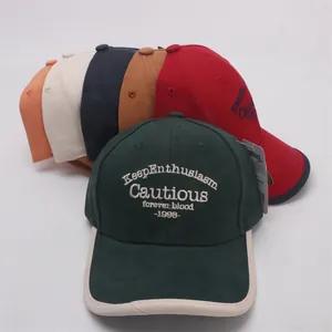 Detail of colorful cotton baseball caps with premium 3D embroidery and contrast brim edge