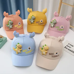 Flat lay of colorful toddler baseball hats with 3D dinosaur plush and GO TOGET embroidery