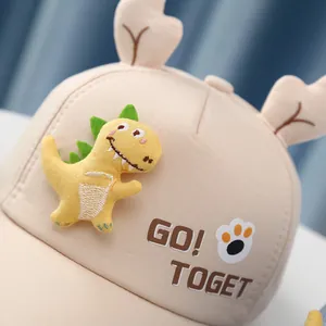 Close-up of cute 3D dinosaur plush patch and deer horn decor on a toddler baseball cap