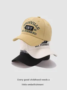 Detailed view of stackable cotton baseball caps with BROSVILLE embroidery in yellow and black