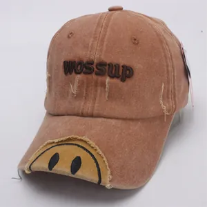 Detail of vintage washed baseball cap with 3D WOSSUP embroidery and distressed brim edge
