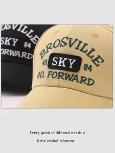 Detailed embroidery of BROSVILLE SKY 49 on cotton baseball caps in beige and black