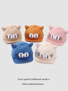 Detailed view of five colorful cotton cartoon baby hats with cute cat ears and embroidery