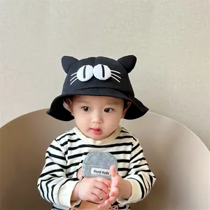 Close-up of kids black bucket hat with 3D cartoon eyes and cute cat ear decorations