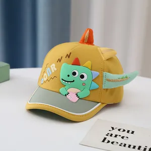 Detail of baby sun hat with 3D cartoon dinosaur and contrast yellow and green brim