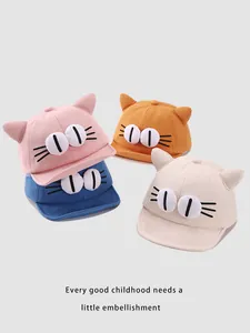 Detail of baby cotton baseball caps featuring 3D cat ears and embroidered eyes