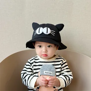 Detail of black baby sun hat with cute 3D cat ears and cartoon eye patches for toddlers