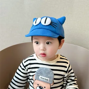 Detail of blue baby baseball cap with cute 3D cat ears and cartoon eyes design