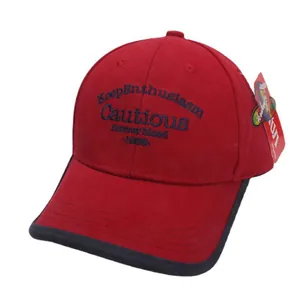 Red cotton baseball cap for kids featuring blue embroidered letters and black brim piping