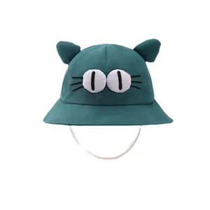 Cute kids green bucket hat with cat ears and cartoon eyes design including chin strap