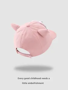 Detail view of the adjustable velcro strap on pink baby baseball cap with animal ears