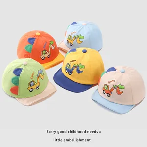 Detail of baby caps with cartoon dinosaur fins and embroidered excavator patterns