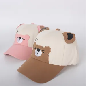 Detail of pink and brown kids baseball caps with 3D bear ears and hi embroidery