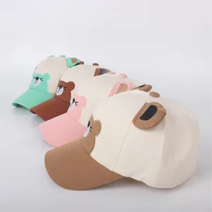 Cute children's baseball caps with cartoon bear ears in four pastel colors on white background