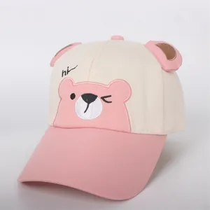 Detail of pink bear embroidery and 3D ears on a cream cotton kids baseball cap