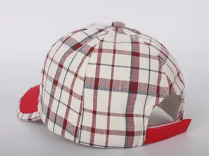 Detailed view of the red adjustable velcro strap on a plaid children's baseball cap