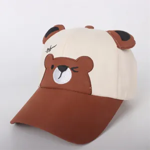 Detail of cartoon bear embroidery and 3D ears on a cotton children's baseball cap