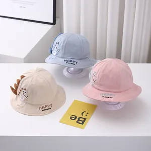 Cute cartoon dinosaur baby bucket hats in blue pink and beige for sun protection.