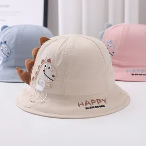 Detailed embroidery of a cartoon dinosaur and HAPPY text on colorful cotton bucket hats