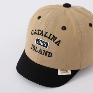 Close-up of contrast baby baseball cap with detailed embroidery and fabric texture