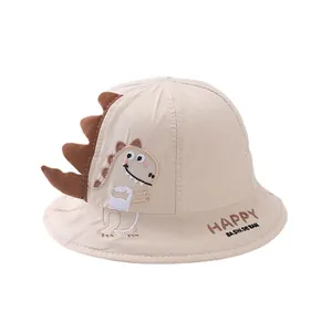 Cute beige kids bucket hat with cartoon dinosaur design and 3D decorative fins