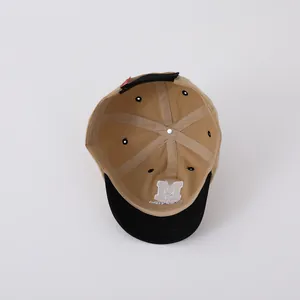 Internal details of kids baseball cap showing M embroidery and reinforced beige stitching