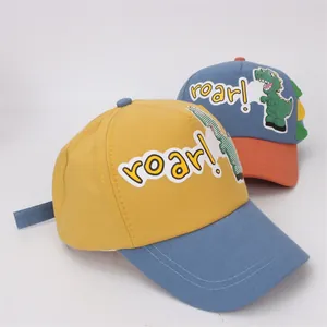 Close-up of children's cotton baseball caps featuring dinosaur embroidery and roar lettering