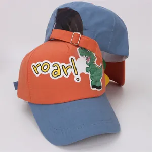 Detail view of cotton kids baseball cap with cartoon dinosaur print and adjustable buckle