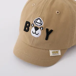 Detailed close-up of khaki cotton baby baseball cap featuring 3D cartoon bear embroidery