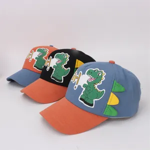 Three children's baseball caps with colorful dinosaur spikes and patchwork design