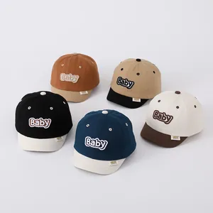 Flat lay of five two-tone cotton baby baseball caps with 3D Baby embroidery detail
