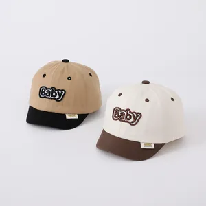 Close-up of baby baseball caps with contrast embroidery and a short brim design