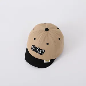 Close-up of baby baseball cap with embroidered lettering and soft short brim