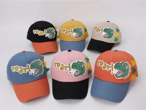 Detail view of colorful children dinosaur baseball caps with 3D fins and roar patch
