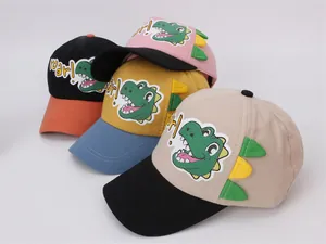 Close-up of colorful kids baseball caps featuring 3D dinosaur scales and roar embroidery