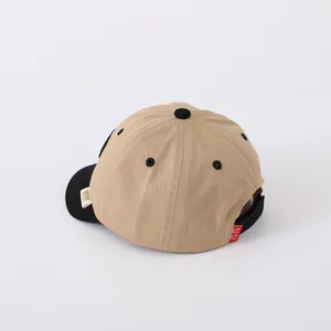 Detail view of khaki and black contrast baseball cap with adjustable rear strap