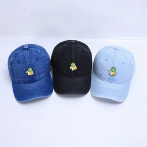 Close-up of baby denim baseball caps with cute monkey and banana cartoon embroidery