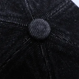 Top-down view of black denim baseball cap showing stitched crown and fabric texture