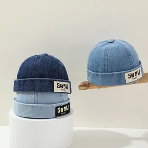 Three vintage denim docker hats for children in dark and light blue shades